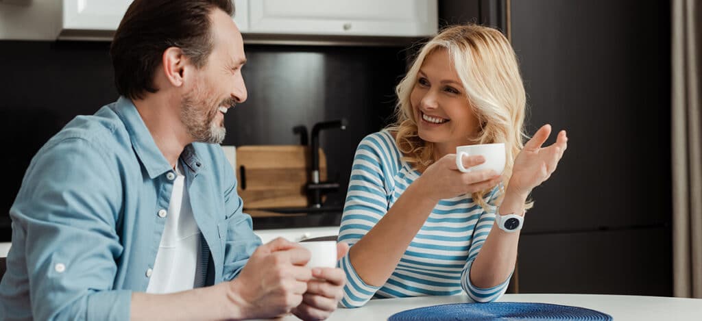 Mature couple drinking coffee together in the kitchen